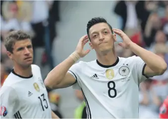  ?? AFP ?? According to Germany manager Joachim Low, players who have resigned such as Mesut Ozil, right, will have no role to play in the future. Ozil quit the national team citing racism