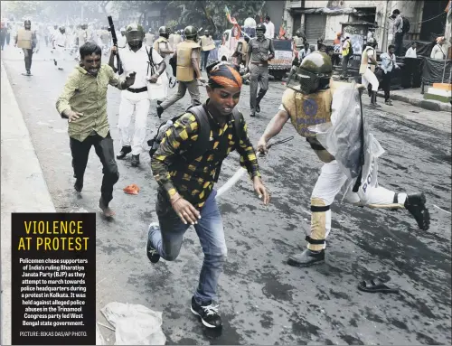  ??  ?? Policemen chase supporters of India’s ruling Bharatiya Janata Party (BJP) as they attempt to march towards police headquarte­rs during a protest in Kolkata. It was held against alleged police abuses in the Trinamool Congress party led West Bengal state...