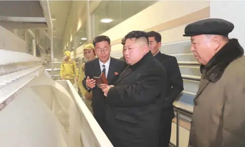  ?? — AFP photo ?? This undated picture released by North Korea’s official Korean Central News Agency (KCNA) on October 30, shows North Korean leader Kim Jong-Un (center) inspecting the Samjiyon Potato Farina Production Factory in Samjiyon County.
