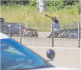  ?? ASHLEE REZIN/ SUN- TIMES ?? Motorists in the outbound lanes of the Dan Ryan Expressway stop to watch and take photos Saturday as thousands of anti- violence protesters pour into the inbound lanes.