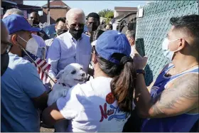  ?? EVAN VUCCI — THE ASSOCIATED PRESS ?? President Joe Biden talks with people as he tours a neighborho­od impacted by flooding from the remnants of Hurricane Ida Sept. 7 in the Queens borough of New York.