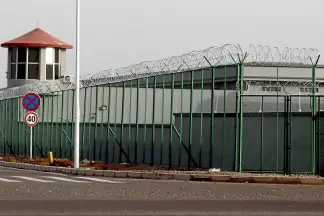  ?? AP ?? A guard tower and barbed wire fences are seen around a facility in the Kunshan Industrial Park in Artux in western China’s Xinjiang region. This is one of a growing number of internment camps in the Xinjiang region, where by some estimates one million Muslims are detained, forced to give up their language and their religion and subject to political indoctrina­tion.