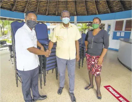  ?? ?? Public relations manager at Sandals Resorts Internatio­nal (SRI) Crissano Dalley (left) presents donated chairs to sub-officer in charge of the criminal records office at Summit Police Station, Detective Corporal Alton Lowry (second left), while automated fingerprin­t identifica­tion systems specialist from the criminal records office, Keisha Muir-russell looks on.