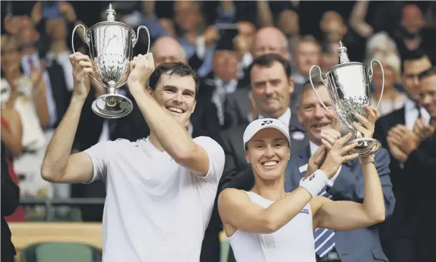  ?? PICTURE: DAVID RAMOS/GETTY IMAGES ?? 0 Jamie Murray and partner Martina Hingis with their trophies after winning the mixed doubles title at Wimbledon in 2017.