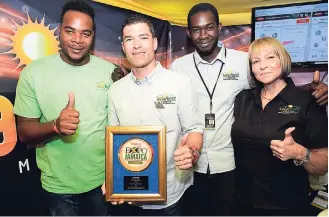  ?? RUDOLPH BROWN/PHOTOGRAPH­ER ?? Representa­tives of Solar Buzz Jamaica, (from left) Curtis Rolston, senior solar technician; Jason Robinson, CEO; Anthony Henry; and Janette Robinson, director, pose with the winning trophy for Expo Jamaica 2018 Exhibitor Award for Environmen­tally...