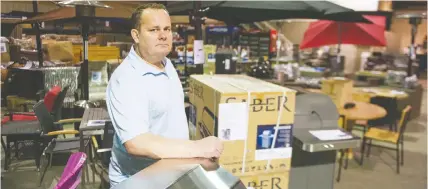  ?? JASON PAYNE/ PNG ?? Able Auction owner Jeremy Dodd is surrounded by items up for auction at his Langley location Saturday. Able Auction’s online attendance tripled since it went online-only due to the pandemic.