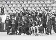  ?? Rick Bowmer, The Associated Press ?? Players from Los Angeles FC take a photo prior to the announceme­nt that their game against Real Salt Lake was called off. Major League Soccer players boycotted five games Wednesday night in a collective statement against racial injustice.