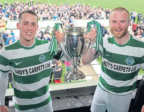  ??  ?? SILVERWARE: Buckie Thistle players Kevin Fraser, left, and Lewis MacKinnon with the Highland League Cup in 2017.