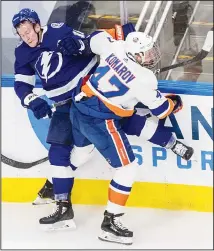  ??  ?? Tampa Bay Lightning’s Ondrej Palat (18) is checked by New York Islanders’ Leo Komarov (47) during the second period of Game 2 of the NHL
hockey Eastern Conference final on Sept 9 in Edmonton, Alberta. (AP)