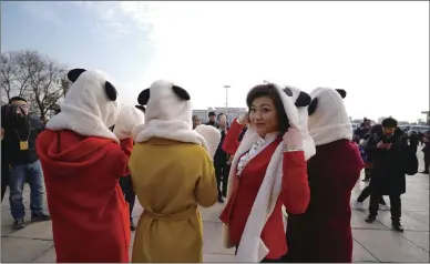  ?? Photo: VCG ?? Reporters from Chengdu TV Station of Southwest China’s Sichuan Province wear panda hats on Monday outside the Great Hall of the People in Beijing, where the first session of the 13th National People’s Congress opened. Chengdu is known as the hometown...