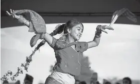  ?? JOSEPH SCHELLER/COLUMBUS DISPATCH ?? Khushi Gurung, 12, dances Oct. 22 during a Tihar festival at Civic Park in Reynoldsbu­rg organized by the Bhutanese Nepali community of Greater Columbus.