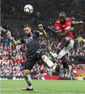  ?? — AP ?? Reliable hitman: Manchester United’s Romelu Lukaku shooting past Crystal Palace’s Damien Delaney during the English Premier League match at Old Trafford yesterday.