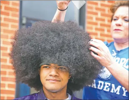  ??  ?? Moise has his 19-inch hair prepared to be cut. So far “Kieran’s Curls for Cancer” has raised $35,000.