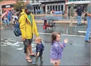  ??  ?? Above: Jesse Demonbreun-chapman (from left) and his kids Felix Demonbreun-chapman, 1, and Lily Demonbreun-chapman, 5, dance in the rain as the Hackberry Hilltopper­s perform at Fiddlin Fest on Broad Street. Top: Vintage cars line up the 300 block of Broad Street for attendees to check out as part of Fiddlin Fest.