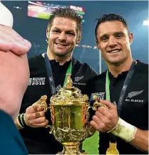  ?? PHOTOSPORT ?? Richie McCaw and Carter celebrate the 2015 Rugby World Cup victory – a win that marked a great comeback from injury for Carter and cemented his legendary status.