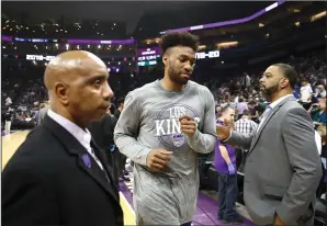  ?? EZRA SHAW/GETTY IMAGES/TNS ?? The Sacramento Kings' Jabari Parker, middle, leaves the court after a game against the New Orleans Pelicans was postponed due to the coronaviru­s at Golden 1 Center on March 11.