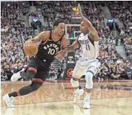  ?? AP ?? Raptors guard DeMar DeRozan drives past Mavericks guard Yogi Ferrell during the first half in Toronto on Friday.