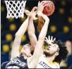  ??  ?? UNC Greensboro’s Hayden Koval (25) and Chattanoog­a’s KC Hankton battle for a rebound during an NCAA college basketball game, on Jan 23, in Chattanoog­a, Tenn. (AP)