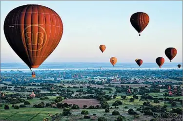  ?? MICHAELA URBAN/PHOTOS FOR THE CHICAGO TRIBUNE ?? Hot-air balloons over Bagan offer aerial views of the many temples in the city in Myanmar.