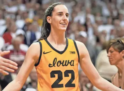  ?? AARON DOSTER/USA TODAY SPORTS ?? Iowa guard Caitlin Clark high-fives teammates as she takes the court before a game at Indiana on Feb. 22.