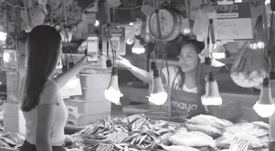  ?? Photo courtesy of Paymaya Philippine­s inc. ?? This undated photo courtesy of Paymaya Philippine­s inc. shows a woman using her mobile phone at a store in Tagbilaran, Bohol. The company announced the roll out in Central Visayas this week of its person-tomerchant payments platform using Quick Response code.