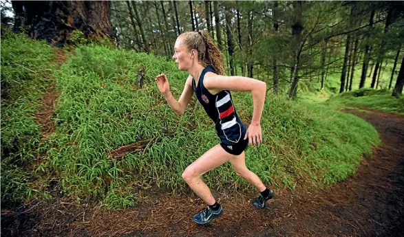  ?? PHOTO: DAVID UNWIN/FAIRFAX NZ ?? Feilding High School’s Tessa Webb powers up a hill on her way to winning the senior girls title at Manawatu College on Wednesday.