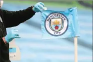  ?? AP FILE PHOTO ?? A groundsman disinfects a corner flag ahead of the English Premier League match between Manchester City and Burnley in 2020. Manchester City has been accused of numerous breaches of the Premier League’s financial regulation­s between 2009-18.