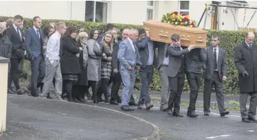  ??  ?? The remains of Raymond Halliday (right) are carried from his home for a funeral at St Luke’s Parish Church, Mullaglass