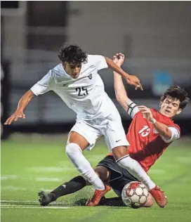  ?? SARA DIGGINS/AMERICAN-STATESMAN ?? Vandegrift’s Aryan Sunder controls the ball as Bowie’s Ben Tillisch goes for the tackle in the second half of the Class 6A boys regional quarterfinal playoff game at House Park on Tuesday. Vandegrift won 1-0 in extra time.