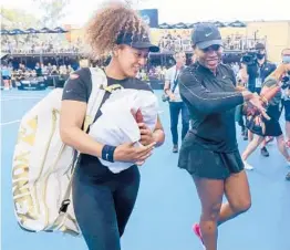  ?? KELLY BARNES/AP ?? Naomi Osaka, left, of Japan, and Serena Williams, of the U.S., walk from the court together following an exhibition tennis event Friday in Adelaide, Australia.