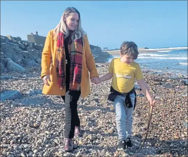  ??  ?? Karen Adam on the beach with her son Isaac