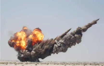  ??  ?? Smoke and fire billow during a controlled explosion by Yemeni experts to destroy explosives and mines laid by Houthi rebels in the southern city of Aden. (AFP)