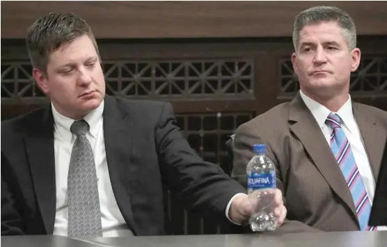 ?? ANTONIO PEREZ/CHICAGO TRIBUNE/POOL ?? Chicago Police Officer Jason Van Dyke and his attorney Daniel Herbert react Friday to the guilty verdict at the Leighton Criminal Court Building.