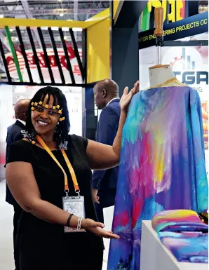  ?? ?? An exhibitor displays a product at the booth of South Africa at the sixth CIIE in Shanghai on 6 November