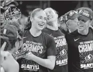  ?? [AP PHOTO/CAROLYN KASTER] ?? Seattle Storm guard Sue Bird, left, holds the championsh­ip trophy with her teammates in September after winning the 2018 WNBA basketball finals. The WNBA is nearly doubling its national TV exposure with a multiyear deal with CBS Sports.