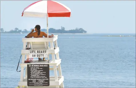  ?? Hearst Connecticu­t Media file photo ?? A lifeguard watches over Calf Pasture Beach in Norwalk last August.