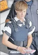  ?? AP PHOTO ?? Dylann Roof is escorted from the Cleveland County Courthouse in Shelby, N.C.