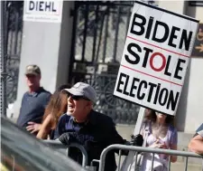  ?? JiM MicHAud / boston HErALd ?? SCREAMING MAD: An anti-vaxxer shouts at a passing motorist during a protest in front of the State House.