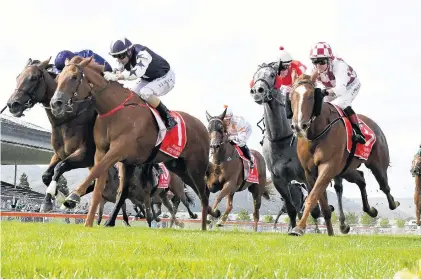  ?? PHOTO CREDIT: PETER RUBERY (RACE IMAGES PALMERSTON NORTH) ?? In good form . . . Scott Base (centre) charges for the line in the group 2 Wellington Guineas at Trentham in March.