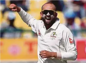 ?? AFP PIC ?? Australia’s Nathan Lyon celebrates taking the wicket of India's Cheteshwar Pujara yesterday.
