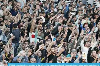  ?? —AFP ?? TEHRAN: A handout picture provided by the office of the Iranian Ayatollah Ali Khamenei shows Iranians gathering to listen to the Iranian supreme leader’s speech at his shrine in Tehran.