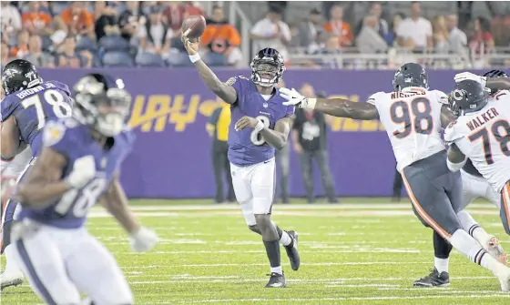  ??  ?? Ravens quarterbac­k Lamar Jackson throws a pass under pressure from Bears defensive tackle Bilal Nichols at Tom Benson Hall of Fame Stadium.