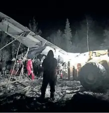  ?? THE CANADIAN PRESS ?? A photo of a plane crash near Fond du Lac, Sask., shows the damaged aircraft partly on its side in the trees. The plane carrying 22 passengers crashed shortly after takeoff in the northern Saskatchew­an town.