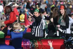  ?? Staff file photo by Jerry Habraken ?? ■ Beads are thrown from atop a float Feb. 25, 2017, during the Mardi Gras Parade in downtown Texarkana.