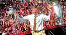  ??  ?? Prize guy: Wenger on a victory tour after doing the Double in 1998