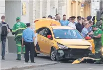  ?? PHOTO: REUTERS ?? Emergency personnel surround a damaged taxi, which ran into a crowd of people in Moscow on Saturday.