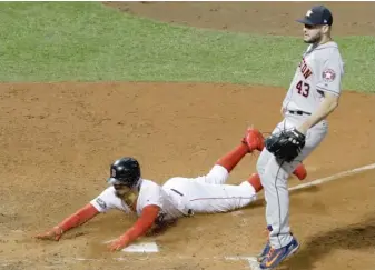  ?? AP ?? Mookie Betts scores on a passed ball in front of Astros pitcher Lance McCullers Jr. in the seventh inning.