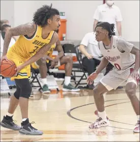  ?? Greg Ott / Rider Athletics ?? Manny Camper of Siena looks to pass the ball against Christian Ings of Rider on Friday. Camper had 17 points, nine rebounds and six assists.