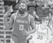  ?? Ross D. Franklin / Associated Press ?? James Harden, left, sees less stress in his future if Chris Paul handles more of the Rockets’ playmaking.