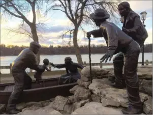  ?? PHOTO BY ANNE BOKMA ?? The Freedom Crossing monument commemorat­ing the Undergroun­d Railroad in Lewiston N.Y. portrays a family being loaded into a boat to make the Niagara River crossing.